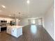 Open concept living area featuring modern kitchen with island, seamlessly blending with a spacious living room at 4501 Sw 110Th Ln, Ocala, FL 34476