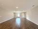 Spacious living room features wood-look tile flooring and a bright, airy feel with neutral paint at 4501 Sw 110Th Ln, Ocala, FL 34476