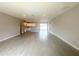 Open-concept living and kitchen area featuring recessed lighting and sleek wood-look tile flooring with gray kitchen island at 4501 Sw 110Th Ln, Ocala, FL 34476