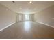 Bright living room features sleek flooring, recessed lighting, and a large window with neutral walls and white trim at 4501 Sw 110Th Ln, Ocala, FL 34476