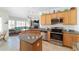 Modern kitchen with stainless steel appliances, granite countertops, and a seamless connection to the living room at 4651 Sw 65Th Pl, Ocala, FL 34474