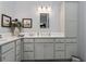 The bathroom offers a modern design with a spacious vanity, stylish fixtures and decorative wall art at 503 Verlander St, The Villages, FL 34762
