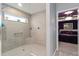 Stylish bathroom showcasing a tiled shower and an open view into the main bedroom at 503 Verlander St, The Villages, FL 34762