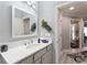 Well-lit bathroom with a quartz countertop, modern faucet, and decorative accents at 503 Verlander St, The Villages, FL 34762