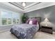 Comfortable bedroom featuring large window, a stylish ceiling fan, and neutral-toned carpet at 503 Verlander St, The Villages, FL 34762
