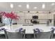 Modern kitchen with a large island, stainless steel appliances, and tiled backsplash at 503 Verlander St, The Villages, FL 34762
