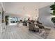 Spacious living room with sliding glass doors, modern furniture, and light wood floors for an airy feel at 503 Verlander St, The Villages, FL 34762