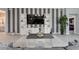 Bright living room with built-in shelving, striped accent wall, and open floor plan at 503 Verlander St, The Villages, FL 34762
