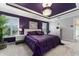 The main bedroom features a luxurious purple color scheme, decorative ceiling, and ample natural light at 503 Verlander St, The Villages, FL 34762