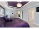 The main bedroom features a luxurious purple color scheme, decorative ceiling, and ample natural light at 503 Verlander St, The Villages, FL 34762