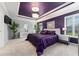 The main bedroom features a luxurious purple color scheme, decorative ceiling, and ample natural light at 503 Verlander St, The Villages, FL 34762