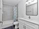 Bathroom with a white vanity, marble-look shower, and gray floors at 509 Marion Oaks Trail, Ocala, FL 34473