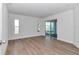 Bright bedroom with wood-look flooring, windows and a sliding glass door at 509 Marion Oaks Trail, Ocala, FL 34473