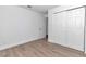 Bright bedroom with wood-look flooring and a closet with sliding doors at 509 Marion Oaks Trail, Ocala, FL 34473