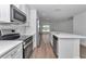 Bright kitchen featuring stainless steel appliances, white cabinets, and a spacious island with a sink at 509 Marion Oaks Trail, Ocala, FL 34473