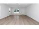 Bright living room with wood-look flooring and a window with natural light at 509 Marion Oaks Trail, Ocala, FL 34473