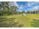 Lush green backyard of single-Gathering home, featuring mature trees and landscaping on a sunny day at 5902 Sw 112Th Place Rd, Ocala, FL 34476