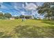 View of expansive backyard of single-Gathering home with lush green lawn and mature landscaping at 5902 Sw 112Th Place Rd, Ocala, FL 34476