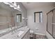 Bright bathroom features a granite countertop, modern fixtures, and a shower with glass door at 5902 Sw 112Th Place Rd, Ocala, FL 34476