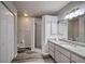 Well-lit bathroom with walk-in shower, granite counters, dual sinks, and ample storage space at 5902 Sw 112Th Place Rd, Ocala, FL 34476