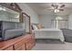 Bright bedroom features a window, ceiling fan, wood dresser with television and a comfortable beanbag chair at 5902 Sw 112Th Place Rd, Ocala, FL 34476