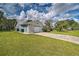 A one-story home featuring a two-car garage, concrete driveway, and lush green lawn at 5902 Sw 112Th Place Rd, Ocala, FL 34476