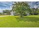 Well-manicured front yard of single-Gathering home with a blossoming tree and landscaped surroundings at 5902 Sw 112Th Place Rd, Ocala, FL 34476