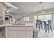 Open concept kitchen with granite countertops, breakfast bar, and adjacent dining area with natural light at 5902 Sw 112Th Place Rd, Ocala, FL 34476