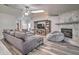 Comfortable living room features a cozy fireplace and stylish wood flooring at 5902 Sw 112Th Place Rd, Ocala, FL 34476