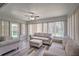 Bright sunroom with neutral furniture, wood-look floors, and large windows offering plenty of natural light at 5902 Sw 112Th Place Rd, Ocala, FL 34476