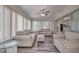 Well-lit sunroom featuring comfortable seating and sliding glass doors to the rest of the home at 5902 Sw 112Th Place Rd, Ocala, FL 34476