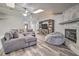 Comfortable living room features a cozy fireplace and stylish wood flooring at 5902 Sw 112Th Place Rd, Ocala, FL 34476