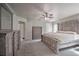 Large main bedroom with a king-size bed, dresser, and multiple entry points at 5902 Sw 112Th Place Rd, Ocala, FL 34476