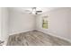 Bedroom with wood-look flooring, window, and ceiling fan at 5910 Sw 111Th Place Rd, Ocala, FL 34476
