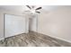 Bedroom featuring wood-look flooring, a ceiling fan, and closet at 5910 Sw 111Th Place Rd, Ocala, FL 34476