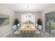 Cozy dining area with natural light, a modern chandelier, and sliding glass doors leading to the backyard at 5910 Sw 111Th Place Rd, Ocala, FL 34476