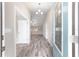 Bright entryway featuring wood-look flooring, a modern chandelier, and a blue glass-paneled front door at 5910 Sw 111Th Place Rd, Ocala, FL 34476