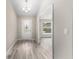 Light, airy entryway featuring wood-look flooring and views into other rooms of the home at 5910 Sw 111Th Place Rd, Ocala, FL 34476
