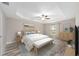 Comfortable main bedroom with a tray ceiling, ceiling fan, and ensuite bathroom at 5910 Sw 111Th Place Rd, Ocala, FL 34476