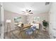 Well-lit office space with a ceiling fan, a large window, and neutral decor for a professional workspace at 5910 Sw 111Th Place Rd, Ocala, FL 34476