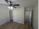Bright bedroom with wood-look floors and closet at 6276 Nw 65 Nw Pl, Ocala, FL 34482