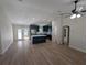 Open-concept living room featuring wood-look floors leading to a kitchen with an island and stainless appliances at 6276 Nw 65 Nw Pl, Ocala, FL 34482