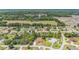 Expansive aerial view showcasing neighborhood homes, green spaces, and distant tree line at 6279 Se 8Th Lane, Ocala, FL 34472