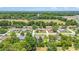 Panoramic view of neighborhood with mature trees, open field nearby, and a community of single-Gathering homes at 6279 Se 8Th Lane, Ocala, FL 34472