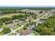 High-angle view of a neighborhood featuring mature trees, with one house featuring a swimming pool at 6279 Se 8Th Lane, Ocala, FL 34472