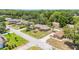 Expansive aerial view of a single-story home nestled among lush greenery in a peaceful neighborhood at 6279 Se 8Th Lane, Ocala, FL 34472