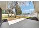 A spacious, grassy backyard featuring trees, a patio, and a white fence line offering privacy at 6279 Se 8Th Lane, Ocala, FL 34472