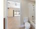 Bathroom and living area shown together through doorway with tan-colored tiling at 6279 Se 8Th Lane, Ocala, FL 34472