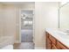 Bathroom leading into bedroom with a double sink vanity with stylish fixtures and tile flooring at 6279 Se 8Th Lane, Ocala, FL 34472