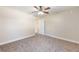 Spacious bedroom with carpet flooring, a ceiling fan, and a doorway leading to another room at 6279 Se 8Th Lane, Ocala, FL 34472